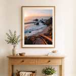 Finished sunset ocean stairway cross stitch artwork displayed as home decor