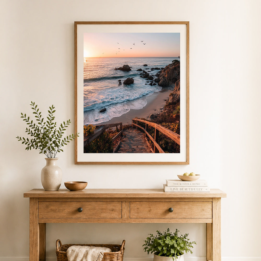 Finished sunset ocean stairway cross stitch artwork displayed as home decor