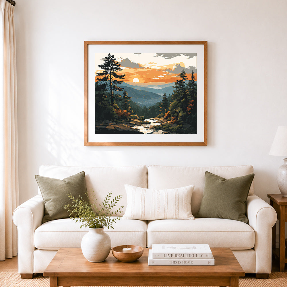 Finished sunset over pine forest and rolling mountains cross stitch artwork displayed as home decor