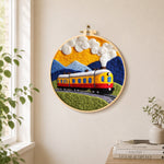 Sunset steam train needle felt wall art displayed in a bright home interior
