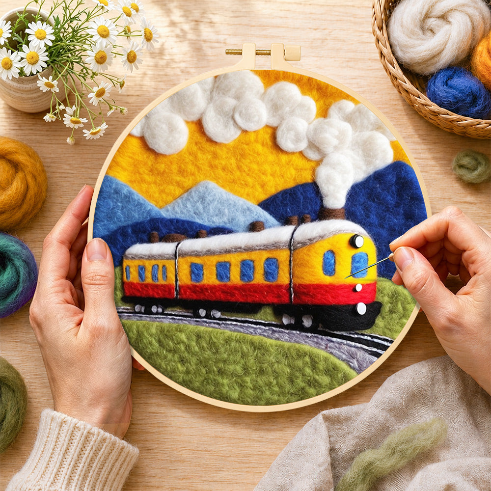 Creating the sunset steam train wool painting by hand with a felting needle
