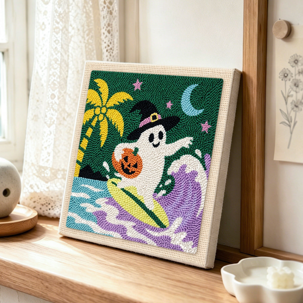 Surfing halloween ghost punch needle artwork displayed on a table