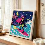 Surfing witch punch needle artwork displayed on a table