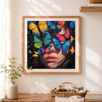 Finished surreal butterfly mask portrait cross stitch artwork displayed as home decor