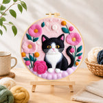 Finished sweet black and white cat with flowers needle felting displayed on a wooden easel