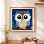 Finished sweet night owl cross stitch artwork displayed as home decor