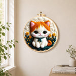 Sweet orange and white kitten needle felt wall art displayed in a bright home interior