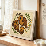 Sweet otter family punch needle artwork displayed on a table