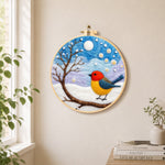 Sweet red and yellow winter robin needle felt wall art displayed in a bright home interior