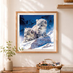 Finished sweet snow leopard cubs on icy rocks cross stitch artwork displayed as home decor