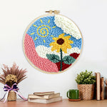 Finished swirly sun and cheerful sunflower artwork displayed on a wall