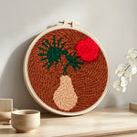 Terracotta sunset botanical punch needle artwork displayed on a table