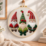 Three christmas gnomes embroidery hoop wall art displayed as warm and cozy handmade home decor