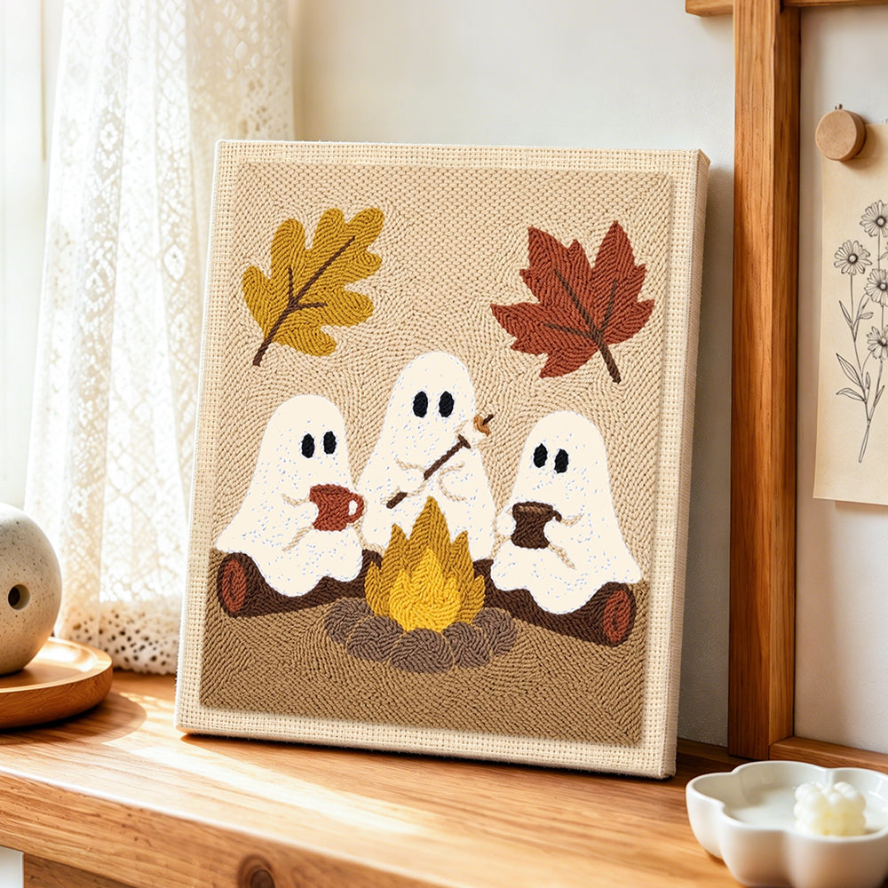Three ghosts around campfire punch needle artwork displayed on a table