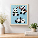 Finished three playful pandas artwork displayed on a wall
