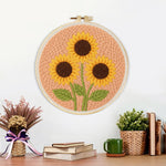 Finished three sunflowers on peachy pink artwork displayed on a wall