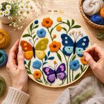 Creating the three whimsical butterflies among flowers wool painting by hand with a felting needle