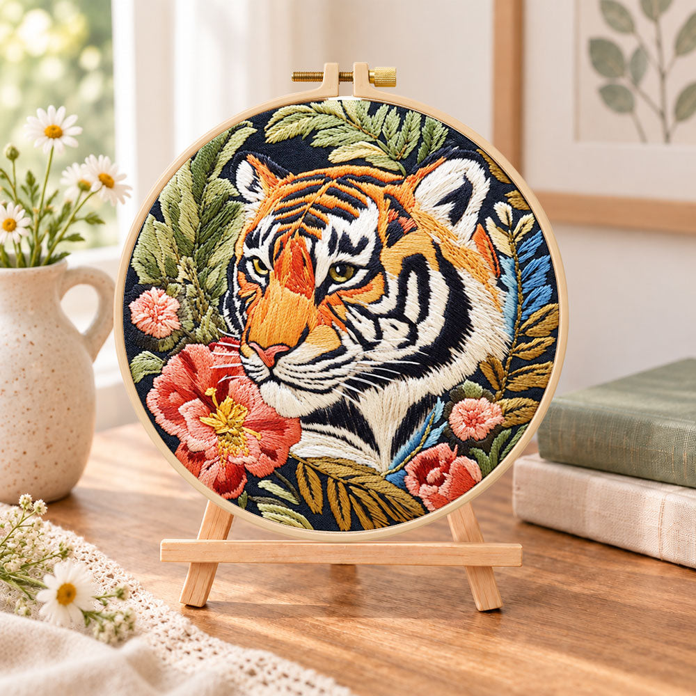 Tiger and red peonies embroidery kit finished hoop displayed on a wooden stand as cozy tabletop decor