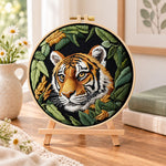 Tiger in dark foliage embroidery kit finished hoop displayed on a wooden stand as cozy tabletop decor