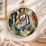Tiger in jungle foliage embroidery hoop wall art displayed as warm and cozy handmade home decor