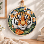 Tiger surrounded by blooms embroidery hoop wall art displayed as warm and cozy handmade home decor
