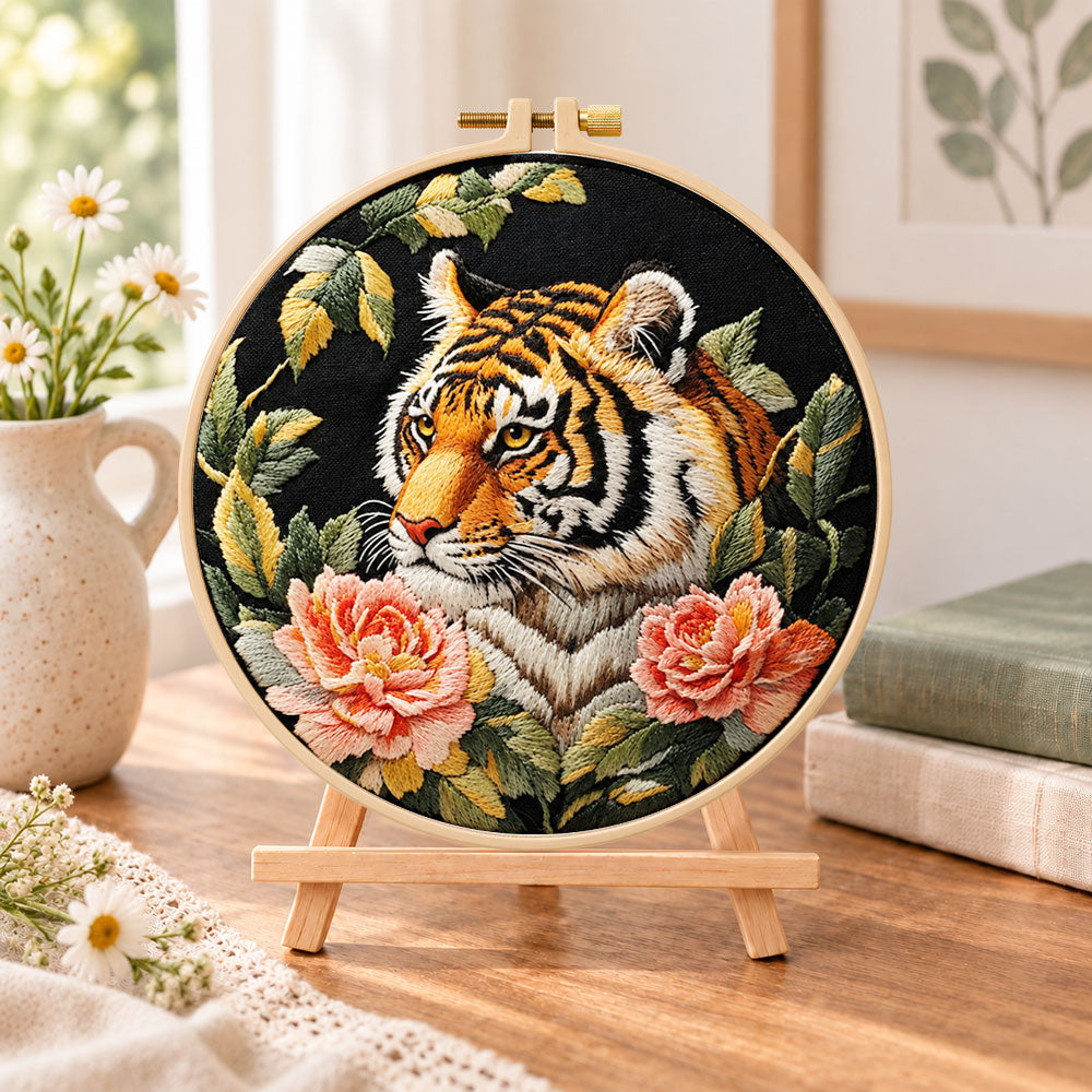 Tiger with pink peonies embroidery kit finished hoop displayed on a wooden stand as cozy tabletop decor
