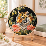 Tiger with pink peonies embroidery kit finished hoop displayed on a wooden stand as cozy tabletop decor