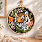 Tiger with wild blooms embroidery hoop wall art displayed as warm and cozy handmade home decor