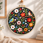 Titmouse and colorful wildflowers embroidery hoop wall art displayed as warm and cozy handmade home decor