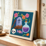 Tombstone floral art punch needle artwork displayed on a table