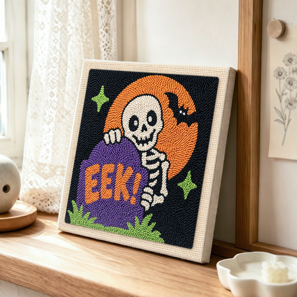 Tombstone skeleton punch needle artwork displayed on a table