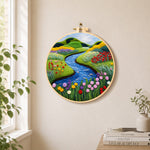 Tranquil river, wildflowers and meadow needle felt wall art displayed in a bright home interior