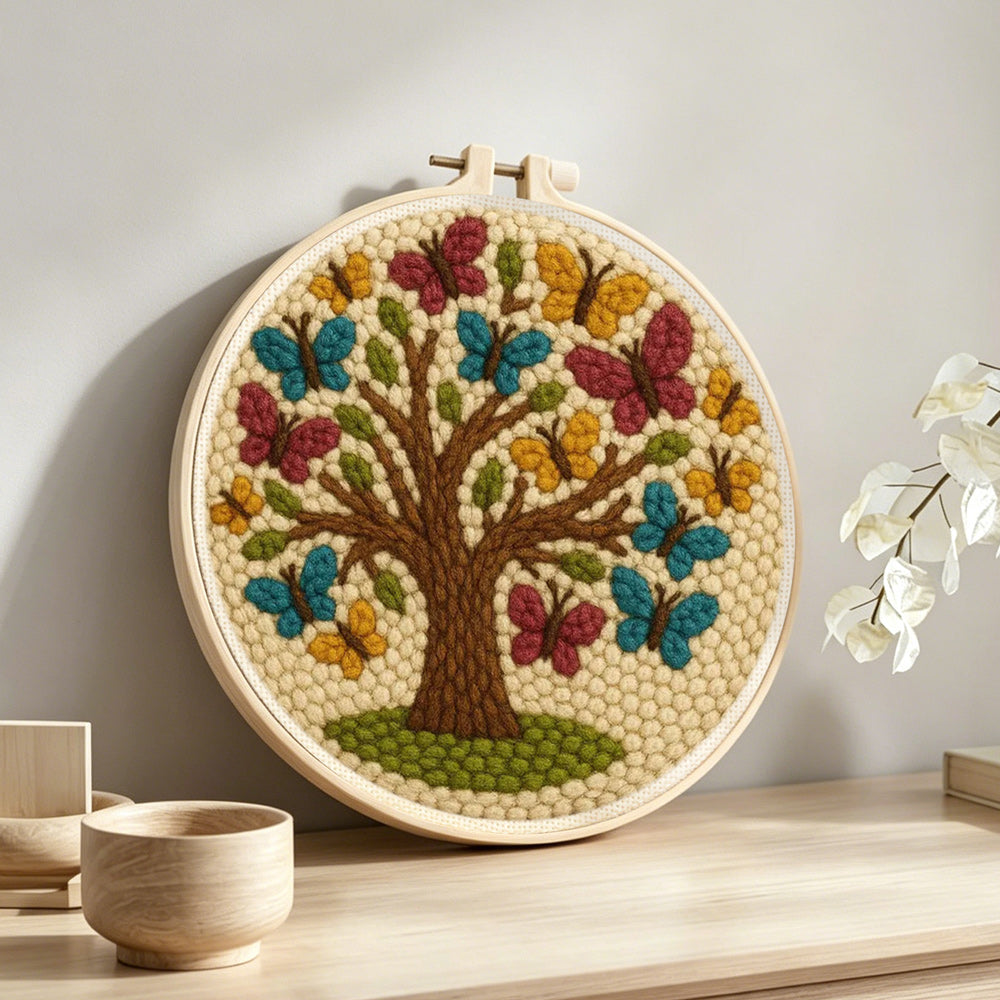Tree of life with colorful butterflies punch needle artwork displayed on a table