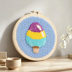 Tri-color ice cream punch needle artwork displayed on a table