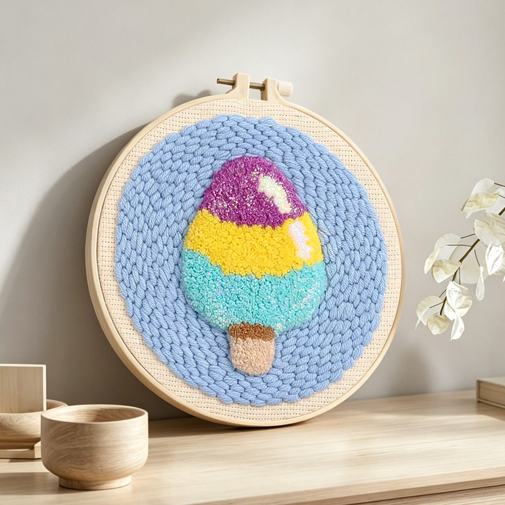 Tri-color ice cream punch needle artwork displayed on a table