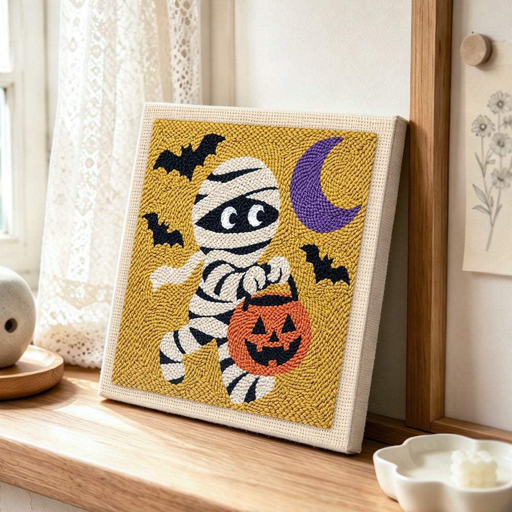 Trick or treat mummy punch needle artwork displayed on a table