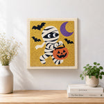 Finished trick or treat mummy artwork displayed on a wall