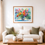 Finished tropical bright floral arrangement cross stitch artwork displayed as home decor
