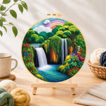 Finished tropical jungle scenery with lush waterfall needle felting displayed on a wooden easel