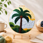 Finished tropical palm tree needle felting displayed on a wooden easel