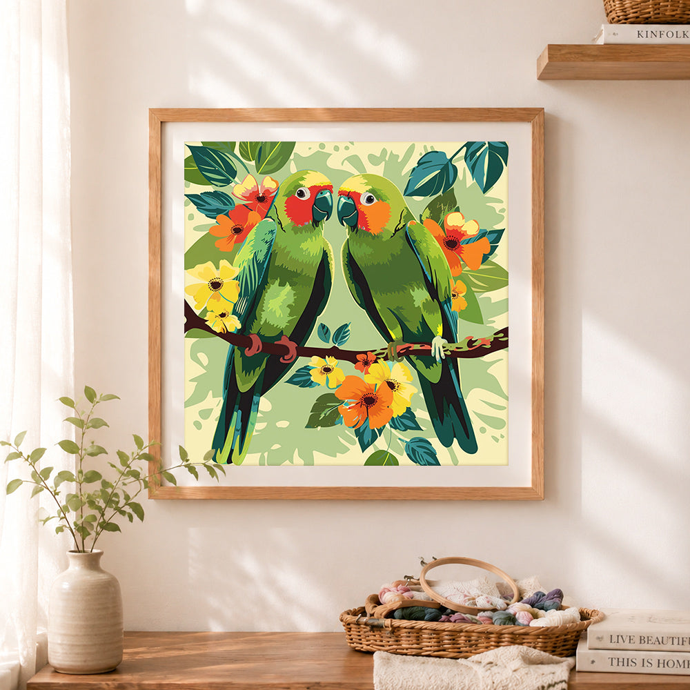 Finished tropical parrot pair cross stitch artwork displayed as home decor