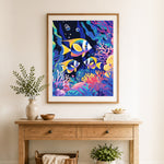 Finished tropical reef fish cross stitch artwork displayed as home decor