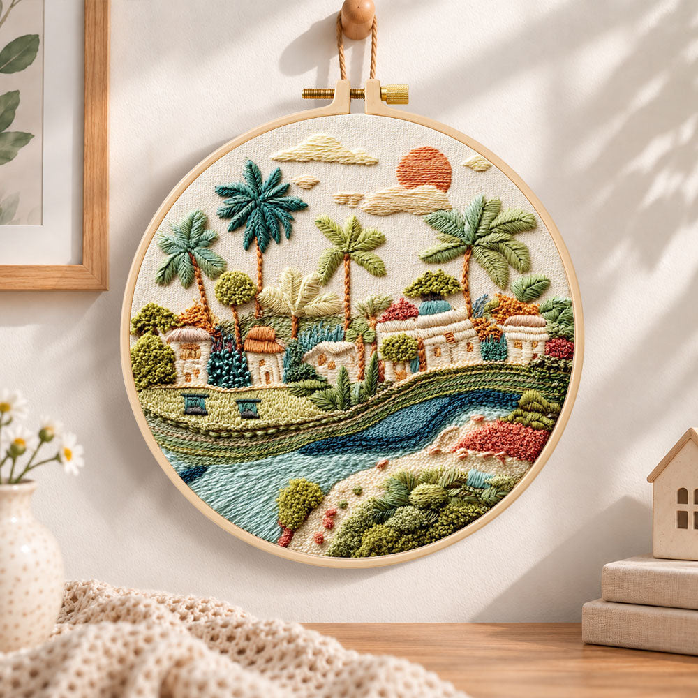 Tropical riverside hamlet embroidery hoop wall art displayed as warm and cozy handmade home decor