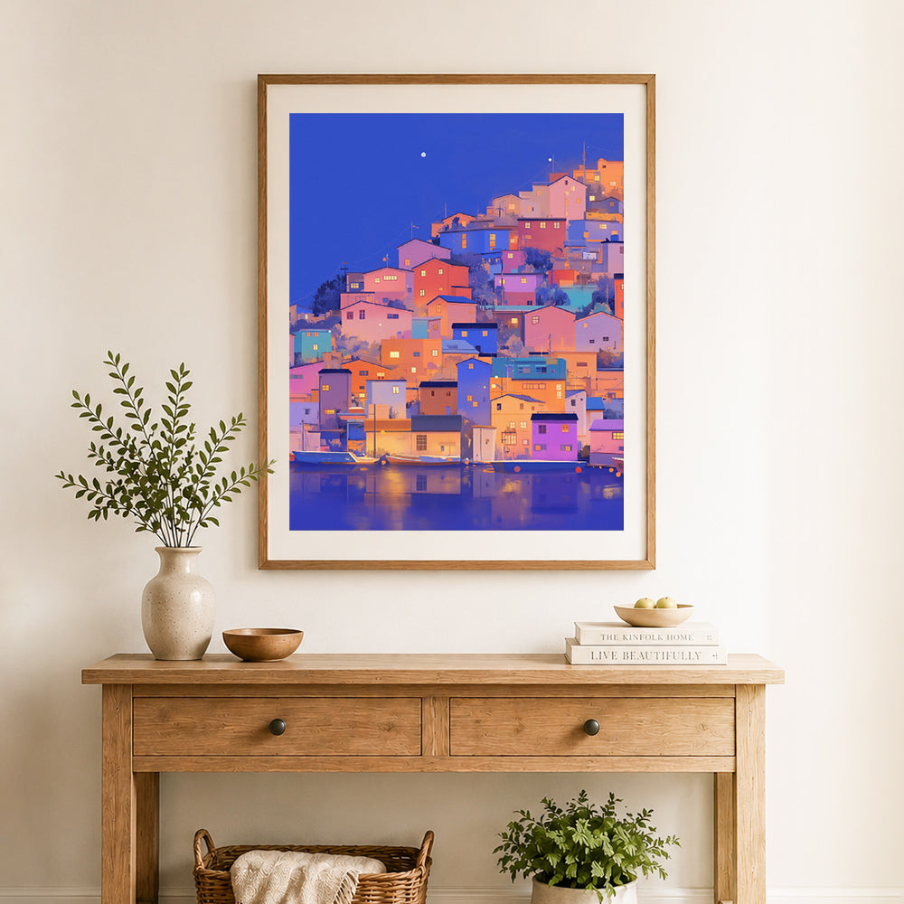 Finished twilight waterfront town cross stitch artwork displayed as home decor