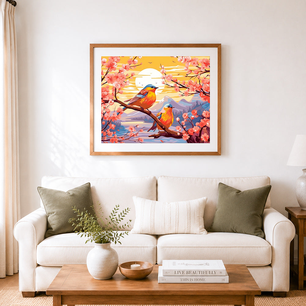 Finished twin birds on cherry branches cross stitch artwork displayed as home decor