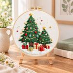 Twinkling christmas trees embroidery kit finished hoop displayed on a wooden stand as cozy tabletop decor