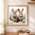 Finished two adorable bunnies in snow cross stitch artwork displayed as home decor