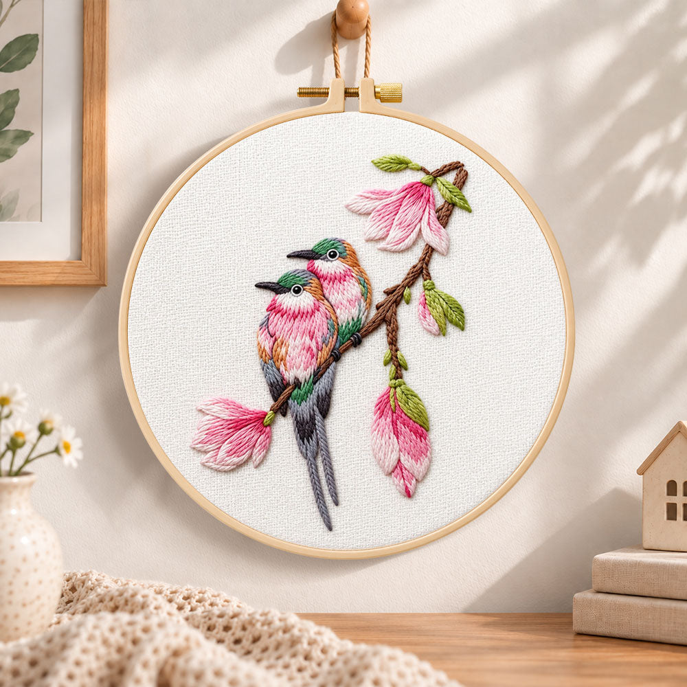 Two birds on magnolia branch embroidery hoop wall art displayed as warm and cozy handmade home decor