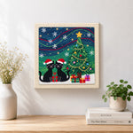 Finished two black cats under christmas tree artwork displayed on a wall