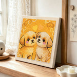 Two cuddly puppies punch needle artwork displayed on a table